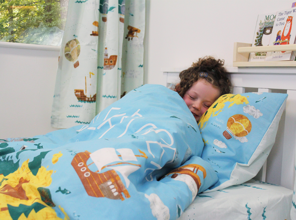 Young child staying cosy in bed