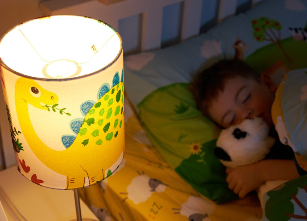 Young boy fast asleep in his bedroom