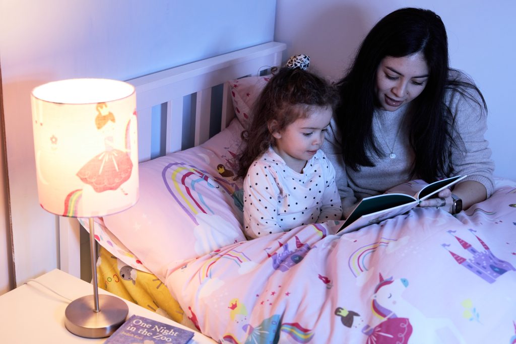 A child and mom share a moment reading a bedtime story together